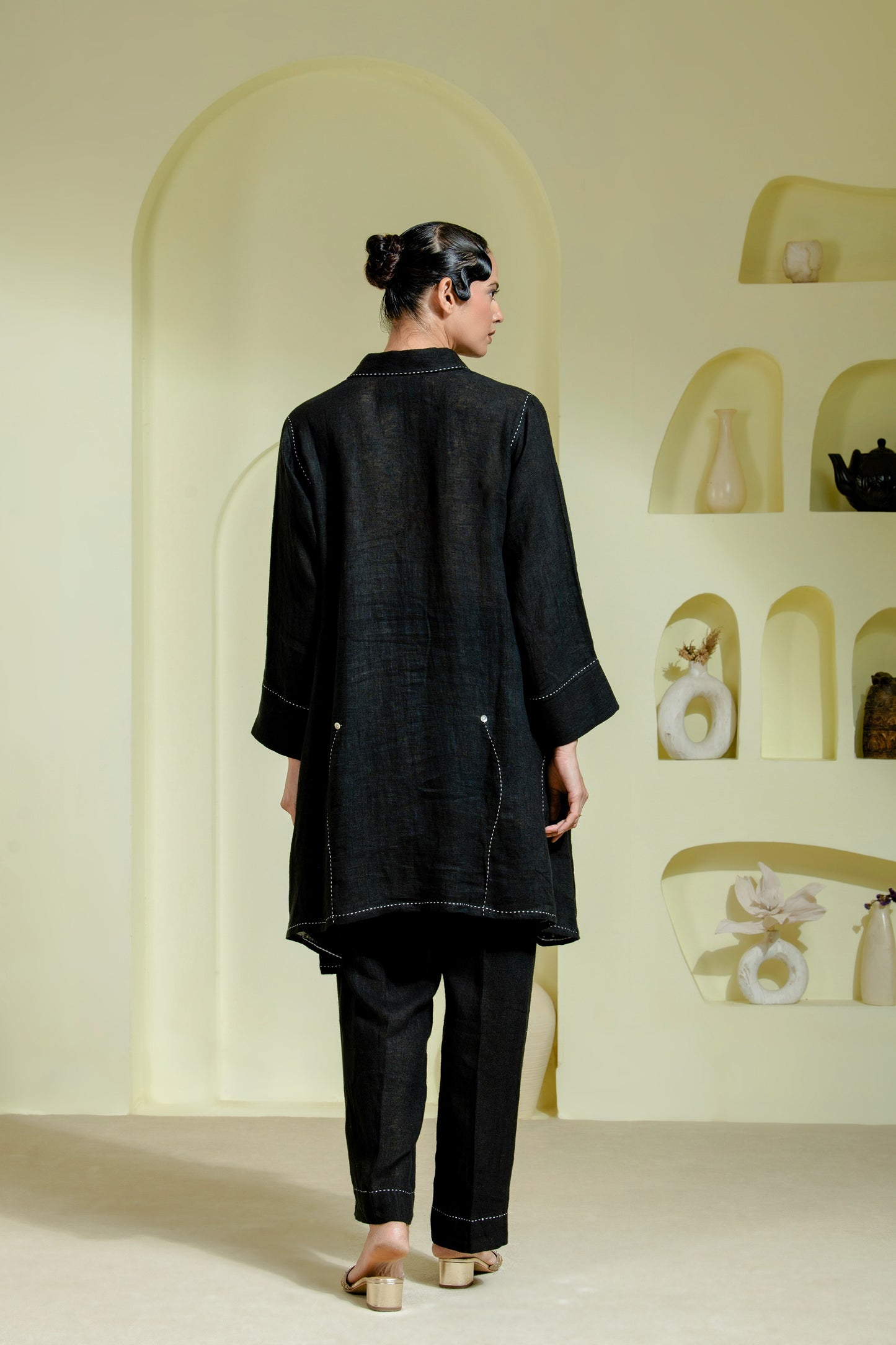 Relaxed silhouette is elevated with asymmetrical hand-done Kantha stitchwork