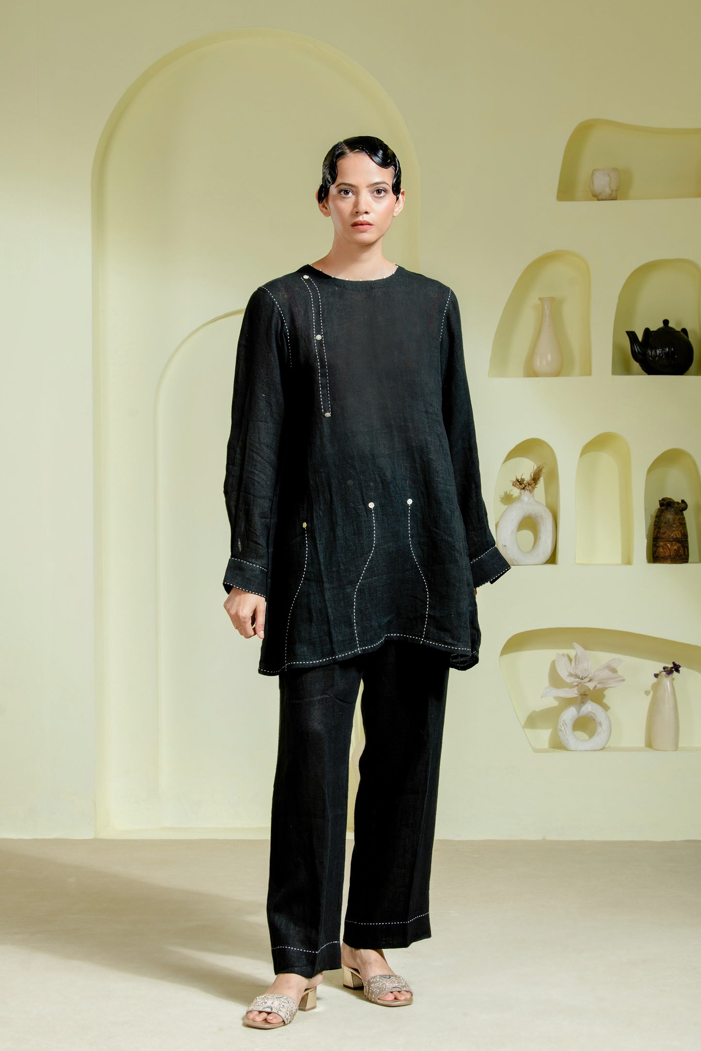 Relaxed silhouette is elevated with asymmetrical hand-done Kantha stitchwork