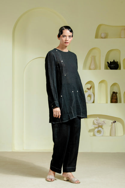 Relaxed silhouette is elevated with asymmetrical hand-done Kantha stitchwork