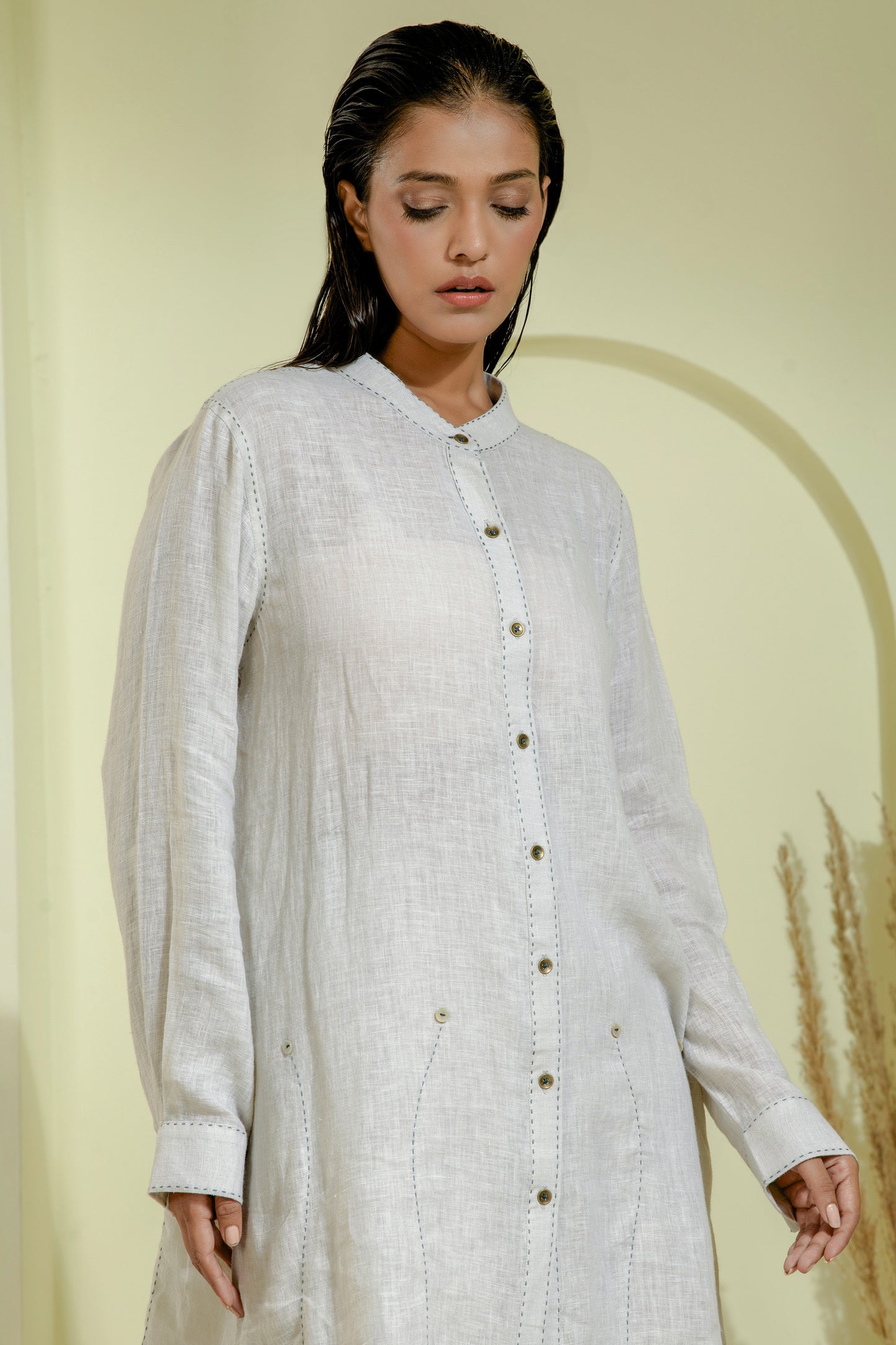 Elegant off-white A-line dress featuring a wrap-style bodice